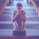 Photo of a praying man in church